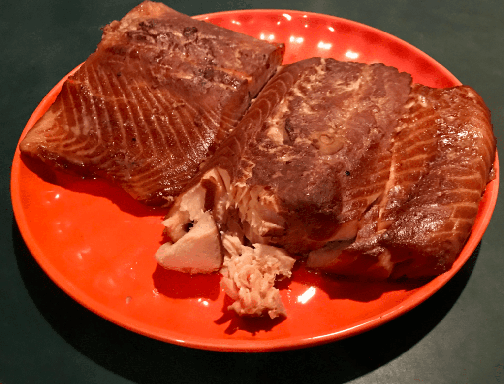 Golden smoked salmon fillets on a plate, prepared using a smoked salmon brine recipe for rich flavor and texture